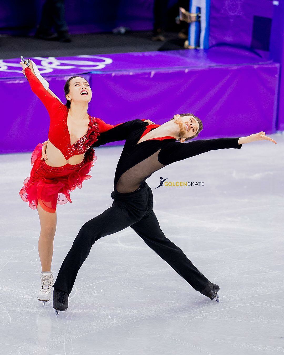 Photo of a man in woman posing while figure skating in bright, coordinating outfits